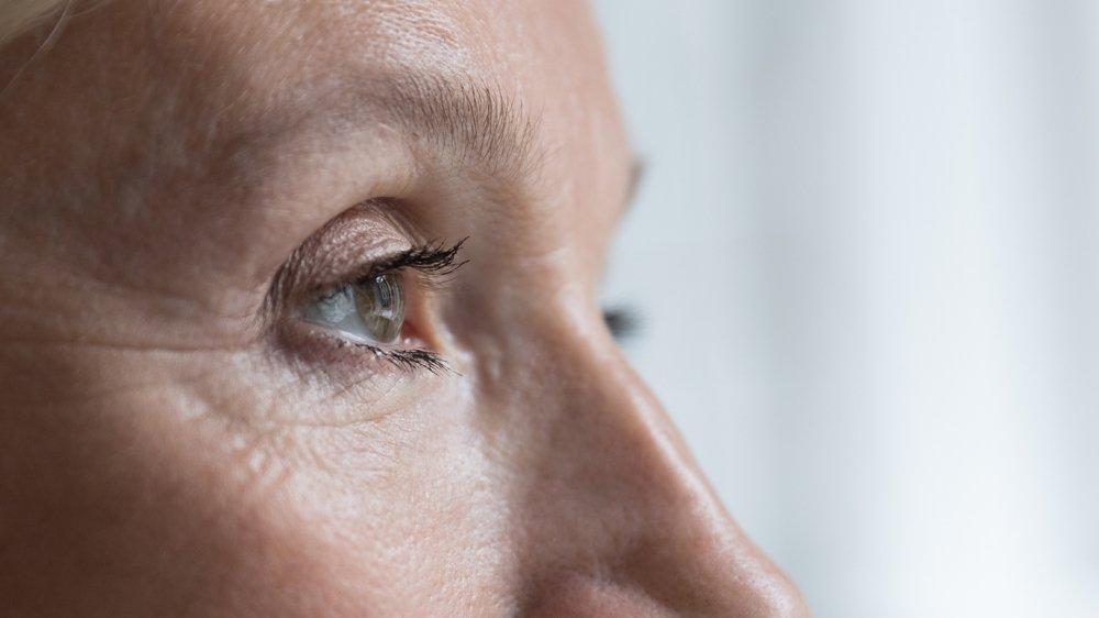 Close-up side view of an older person’s face, focusing on the eye and surrounding skin with visible wrinkles and fine lines—an ideal subject to illustrate advancements like ray-tracing LASIK. The background is softly blurred with natural light.