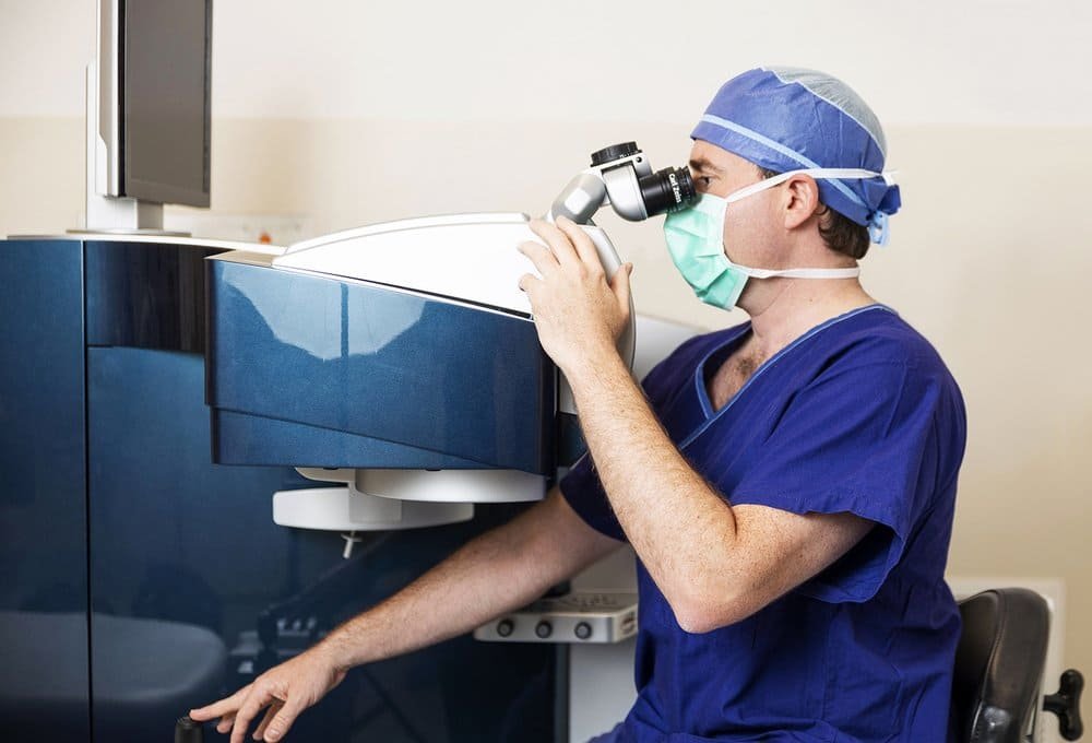 Dr. David Gunn operating a machine for premium pterygium surgery in Brisbane with no-stitches approach