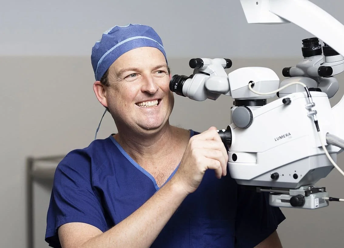Dr Brendan Cronin performing eye surgery using machine with implantable contact lens.
