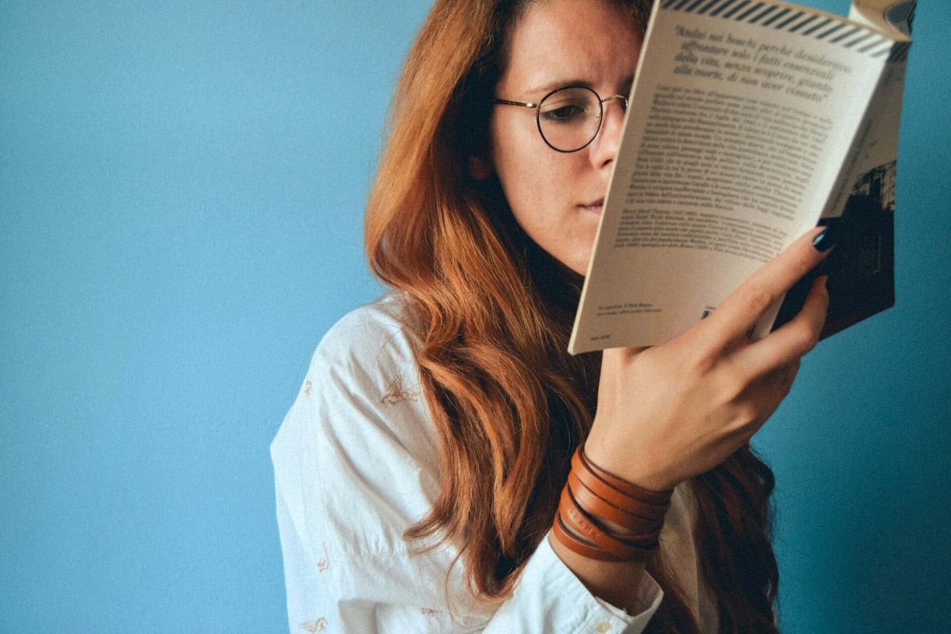 Women reading a book with glasses before laser for reading glasses treatment